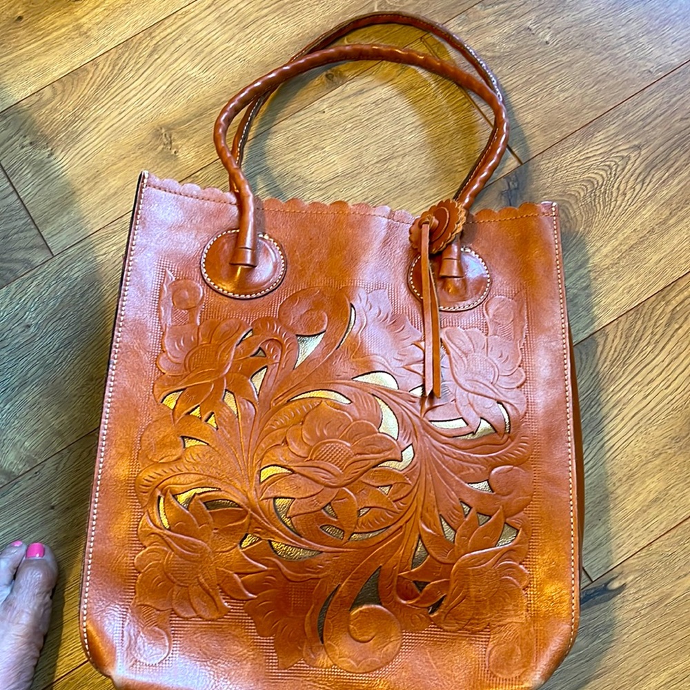 Patricia Nash large tooled tote in saddle. Exterior phone pocket
